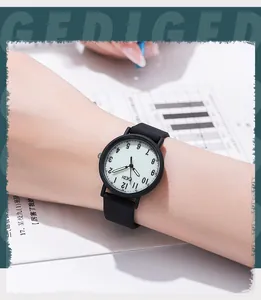Close-up of GEDI quartz watch with matte black silicone strap and white minimalist dial