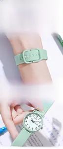 Close-up of mint green silicone strap and minimalist round dial of GEDI quartz watch