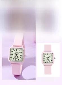 Macro detail of square quartz watch with pink silicone strap and round rectangular dial