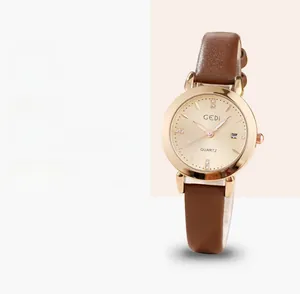 Macro view of leather strap and rose gold quartz watch dial with date display