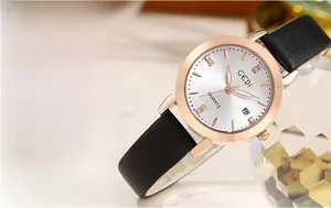 Close-up of rose gold watch dial featuring crystal indices and date display window