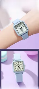 Close-up of a square quartz watch with light blue silicone strap and yellow dial