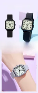 Close-up of a square quartz watch with a soft silicone strap and minimalist beige dial