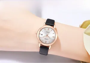 Macro shot of a quartz lady watch with rose gold case and black leather strap on wrist