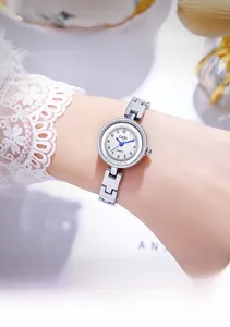 Close-up of elegant silver chain watch with white diamond-set dial and quartz movement