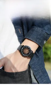 Macro shot of men's vintage quartz watch with gradient dial and black leather strap