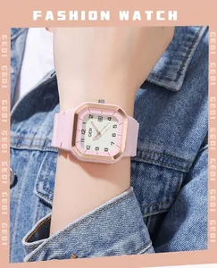 Gros plan d'une montre GEDI rose carrée avec lunette or rose et bracelet en silicone