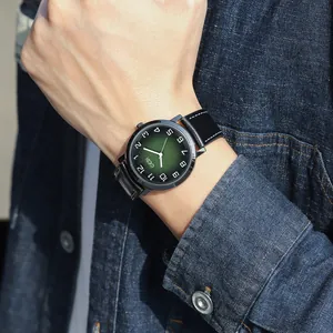 Vintage men's quartz watch with gradient green dial and black leather strap on wrist