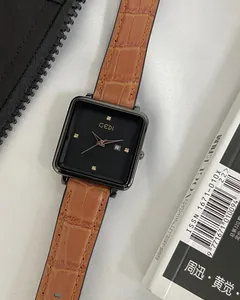Detailed macro view of the square watch dial with rose gold hands and date window