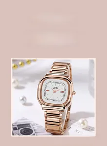 Detail of rose gold tonneau watch with white dial and elegant jewelry accessories