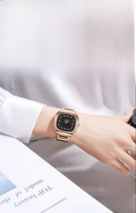 Detail of rose gold square quartz watch on wrist with a sophisticated black dial