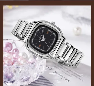 Silver stainless steel square quartz watch with black dial placed next to elegant pearls