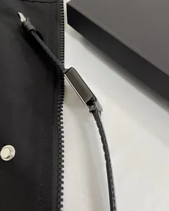 Detail of square black quartz watch with silver polished case and textured leather strap