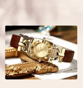 Macro detail of the vintage square gold watch case with leather band and Roman numerals