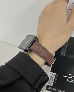 Wrist shot of a retro square quartz watch with brown crocodile leather strap and black dial