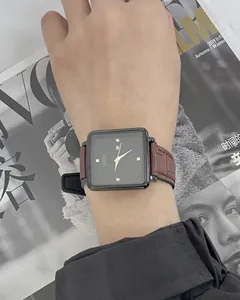 Close-up of GEDI square dial quartz watch with brown leather strap on woman's wrist