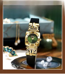 Macro shot of green mother of pearl square dial watch with black leather strap detail