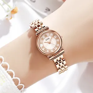Close-up of GEDI rose gold quartz watch with vintage Roman numeral dial on a wrist.