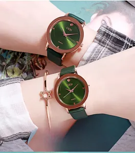 Close-up of green dial quartz watch with rose gold case and matching metal bracelet
