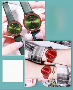 Close-up of GEDI quartz watch dial with sunray pattern and leather straps in red and green