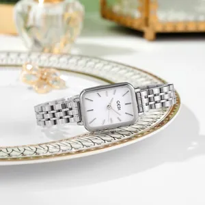 Minimalist silver steel watch for women with rectangular white dial on white porcelain