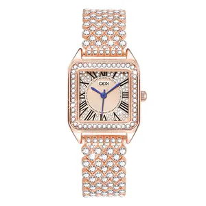 Close-up of rose gold square watch featuring luxury full diamond inlay and blue hands