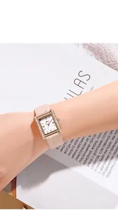 Detail of a square quartz watch with crystal bezel and quilted pink leather strap