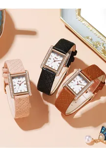 Macro shot of square quartz watches with diamond bezels and diamond-quilted leather straps
