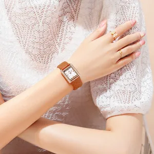 Elegant rectangular rose gold watch with brown quilted leather strap and diamond bezel