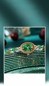 Detail der Gedi Luxusuhr mit smaragdgrünem Zifferblatt und goldenem Kleeblatt-Armband