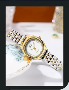 Close-up of a tonneau-shaped watch dial with rhinestones and gold-tone steel band