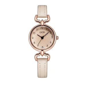 Detail of rose gold case with matte black dial and diamond markers on beige leather strap