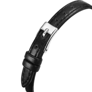 Detailed macro view of black leather watch strap with lychee texture and silver buckle