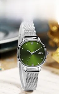 Macro shot of GEDI women's watch with green sunray dial and silver mesh strap
