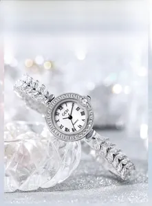 Close-up of mother-of-pearl watch dial with Roman numerals and wheat-link zircon band