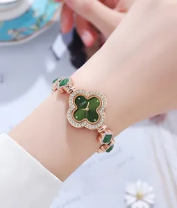 Close-up of green malachite clover dial watch with crystal-encrusted bezel and bracelet