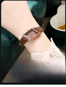 Close-up of a vintage rhombus quartz watch with a brown leather strap and rose gold case