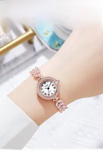 Close-up of a rose gold quartz watch featuring a crystal leaf strap and mother of pearl dial