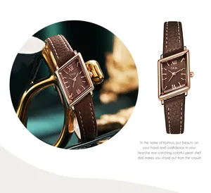 Detail of rose gold rhombic watch case with brown leather strap and Roman numeral dial