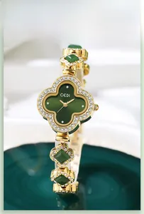 Detailed close-up of a GEDI clover-shaped quartz watch with green dial and gold finish
