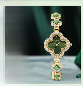Detail of four-leaf clover watch with green agate dial and gold rhinestone-set bracelet