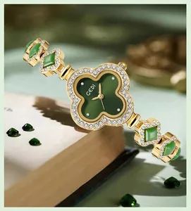 Detail of luxury clover watch with green malachite dial and gold crystal bracelet