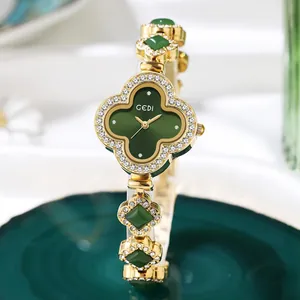 Elegant gold quartz watch with green clover dial and sparkling crystal bracelet for women