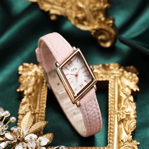 Vintage rose gold rectangular quartz watch with pink leather strap on green silk