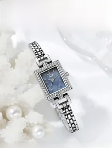 Detail of square quartz watch with blue mother of pearl dial and rhinestone bezel