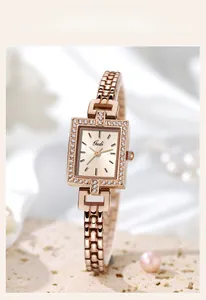 Detailed shot of rose gold square watch with crystal bezel on elegant satin background