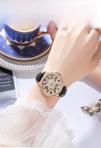 Close-up of Gedi lady watch with rose gold rhinestone dial and black leather strap
