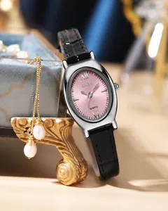 Detailed macro of an elegant oval silver quartz watch with a pink sunburst texture dial