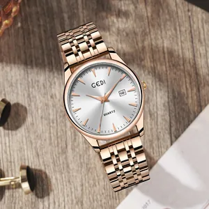 Orologio al quarzo GEDI oro rosa con data e quadrante argento su base in legno