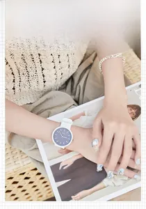 Close-up of GEDI white silicone watch with dark blue dial on a female wrist